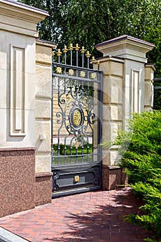 Iron wrought iron gates entrance to the territory of the mansion.