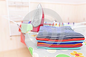 Ironed clothes on an ironing board.