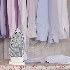 Ironed items and iron on ironing board