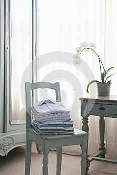 Ironed Shirts On Wooden Chair