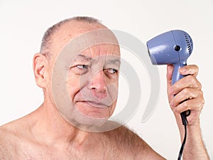 Ironic - Bald man using hair dryer