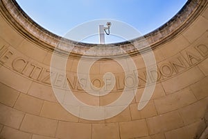 Ironic contrast of security camera and stone carving photo