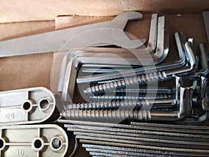 Ironmongery silver bronze iron stainless steel wrench tapping repair cardboard background macro photo photo