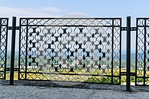 Ironwork metal fence - detail of beautiful decorative manual forged metal fence