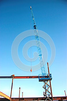 Ironworkers Fit-Up a Steel Beam Suspended from Crane