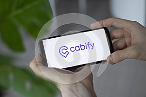IRPEN, UKRAINE - JANUARY 20 20223, Closeup of smartphone screen Cabify logo lettering with in man's hands
