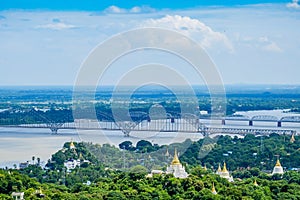 Irrawaddy Bridge or Ayeyarwady, Yadanabon Bridges with Mandalay city, temples, pagoda, Irrawaddy river. View from sagaing hill.