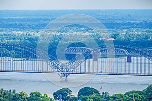 Irrawaddy Bridge or Ayeyarwady, Yadanabon Bridges with Mandalay city, temples, pagoda, Irrawaddy river. View from sagaing hill.