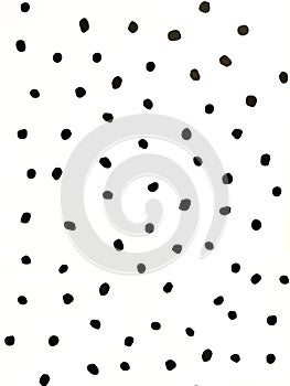 Irregular black polka dot on white wall