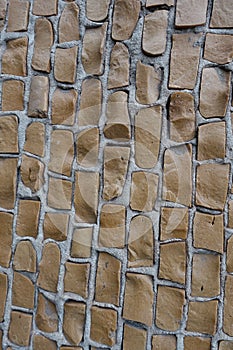 Irregular brown mosaic on the wall