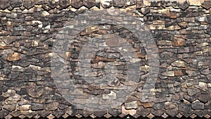 An irregular pattern of roof tiles in an ancient temple in Thailand.