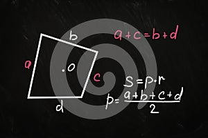 Irregular quadrilateral perimeter and area formulas written on chalkboard photo