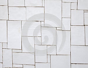 Irregular white tiles on a wall photo