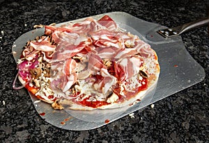 Gourmet Pizza Ready for Oven - Savory Delights Await photo