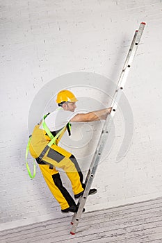 Irresponsible use of a ladder during construction work.