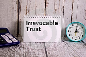 Irrevocable trust document with text on wooden background photo