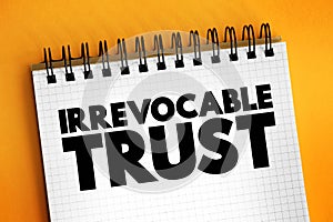 Irrevocable Trust - grantor cannot change or end the trust after its creation, text concept on notepad photo