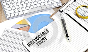 IRREVOCABLE TRUST text on notebook with chart and keyboard