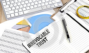 IRREVOCABLE TRUST text on notebook with chart and keyboard photo