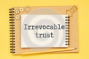 IRREVOCABLE TRUST text on sticker with pen on the black background photo