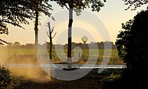 irrigation farm fields sunset hot air balloon water trees