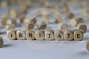 Irritate - cube with letters, sign with wooden cubes