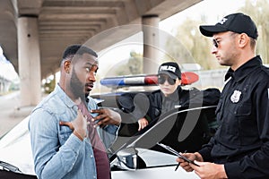 Irritated african american victim gesturing while