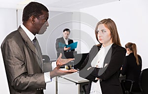 Irritated boss scolding female