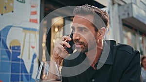 Irritated business man calling cellphone at bar closeup. Mad macho quarrelling