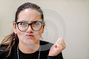 An irritated lady pursing her lips at the camera