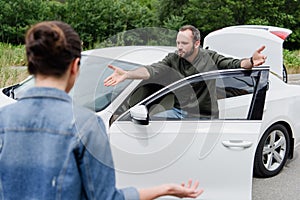 irritated man screaming on driver on road after