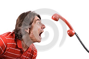 Irritated man screams into the telephone receiver