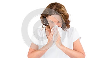 Irritated mature woman sneezing