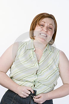 Irritated Obese Woman Unable To Button Jeans