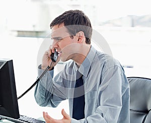 Irritated office worker on the phone