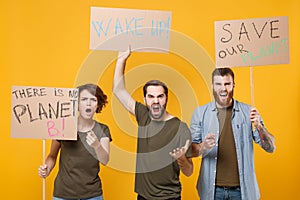 Irritated protesting young people hold protest signs broadsheet placard spreading hands scream isolated on yellow