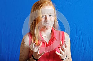 Irritated teen on blue background