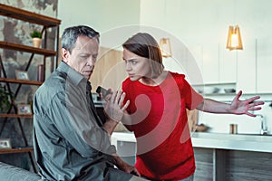 Irritated wife humiliating her mature husband