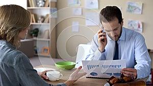 Irritated wife trying to talk with busy husband in business suit, wrangle