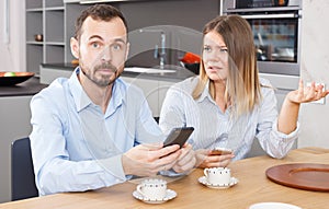 Irritated spouses with phones photo