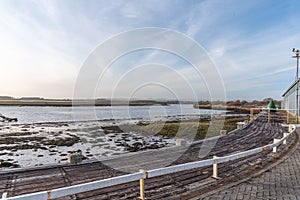 Irvine Harbour in Ayrshire Scotland looking over the Old Seaweed and Lichen Covered flats of the harbour to Ardeer in the far