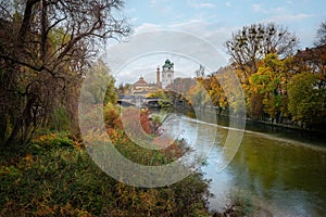Isar River during Autumn Season with Mullersches Volksbad - Munich, Bavaria, Germany photo