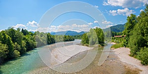 Isar river with gravel banks, green riverside and alps view