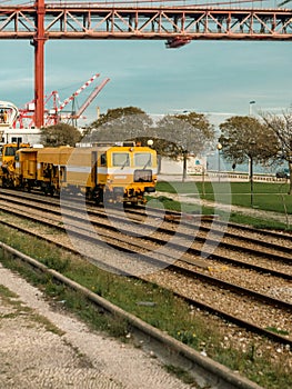 isbon\'s Sunshine Commute - Yellow Train on Rails in Port