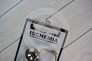 Ischemia write on a paperwork isolated on Wooden Table photo