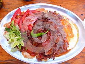 Iskender doner kebap with yoghurt and salad.