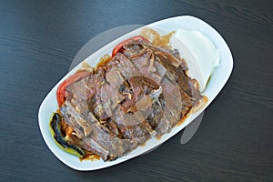 Iskender kebab on a wooden surface at a restaurant top view