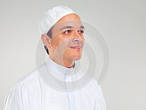 Islam, culture and portrait of muslim man with smile on face in ramadan isolated on grey background. Youth, spiritual