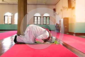 Islam muslim man in custom dress praying in mosque