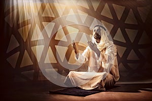 Arab muslim man praying for god blessing during period of ramadan photo
